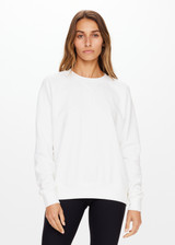 THE UPSIDE women's white Newport Crew is made for a relaxed fit with organic cotton french terry and features ribbed neck, cuffs and waist.