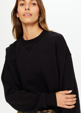 THE UPSIDE Dominique Crew in Black is a sustainable organic cotton cropped fleece crew with a high neck band in soft rib and our horseshoe logo at front.