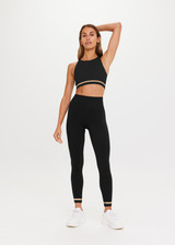 THE UPSIDE Form Seamless 25inch Midi Pant in Black is a solid knitted seamless mid-rise 7/8 length midi pant with contrasting classic sporty strips at cuff.