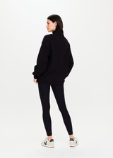 THE UPSIDE Jerome Half Zip Crew in Black is a sustainable organic cotton oversized half zip crew with a soft rib hem and cuffs and kangaroo pocket