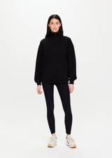 THE UPSIDE Jerome Half Zip Crew in Black is a sustainable organic cotton oversized half zip crew with a soft rib hem and cuffs and kangaroo pocket