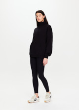 THE UPSIDE Jerome Half Zip Crew in Black is a sustainable organic cotton oversized half zip crew with a soft rib hem and cuffs and kangaroo pocket