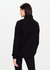 THE UPSIDE Jerome Half Zip Crew in Black is a sustainable organic cotton oversized half zip crew with a soft rib hem and cuffs and kangaroo pocket
