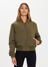 THE UPSIDE Kita Bomber Jacket in Khaki is sustainable classic bomber jacket with pockets, zip front closure, recycled insulation, and PCR free water repellent coating.