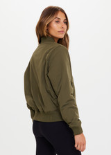 THE UPSIDE Kita Bomber Jacket in Khaki is sustainable classic bomber jacket with pockets, zip front closure, recycled insulation, and PCR free water repellent coating.