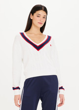 THE UPSIDE Deuce Sonny Knit Sweater is a sustainable classic white tennis knit sweater with a ribbed V neckline and knitted red and navy stripes.