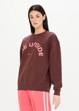 THE UPSIDE Saturn Crew in Chocolate Brown is a sustainable organic cotton relaxed and oversized crew with our printed horseshoe logo at front chest in pink and ribbed cuff and neckline.