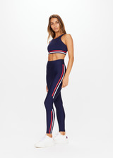 THE UPSIDE Playback 25inch Midi Pant in Navy is a sustainable mid-rise midi pant with printed stripe detail down legs and rubber arrow badge at centre back.
