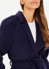 THE UPSIDE Voss Coat in Navy is a heavyweight felted coat with pockets, storm flap and peak lapels, raglan sleeves with belted cuffs and buttons, and removable belt.