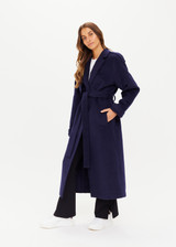 THE UPSIDE Voss Coat in Navy is a heavyweight felted coat with pockets, storm flap and peak lapels, raglan sleeves with belted cuffs and buttons, and removable belt.