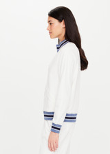 THE UPSIDE Bounce Quinn Jacket in White is a sustainable organic cotton fully lined zip through jacket with pockets, raglan sleeves and stripe rib collar, cuffs and hem.