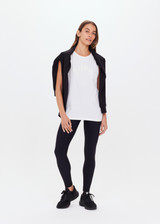 THE UPSIDE women's white Jeet Muscle Tank in organic cotton jersey is a relaxed fit tank with folded detailing and a printed tonal horeshoe logo.