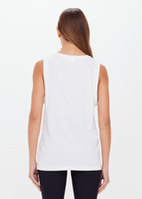 THE UPSIDE women's white Jeet Muscle Tank in organic cotton jersey is a relaxed fit tank with folded detailing and a printed tonal horeshoe logo.