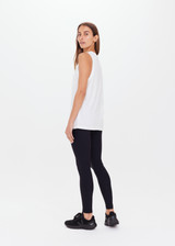 THE UPSIDE women's white Jeet Muscle Tank in organic cotton jersey is a relaxed fit tank with folded detailing and a printed tonal horeshoe logo.