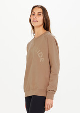 THE UPSIDE women’s brown Newport Crew, made with organic cotton french terry fabric, features a relaxed-fit, rib neck, cuffs and waist, and a tonal printed horseshoe logo on front.