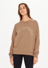 THE UPSIDE women’s brown Newport Crew, made with organic cotton french terry fabric, features a relaxed-fit, rib neck, cuffs and waist, and a tonal printed horseshoe logo on front.