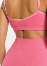 THE UPSIDE womens neon pink mid-rise Ribbed Seamless 5 Inch Spin Short made with Ribbed Seamless fabric features reverse rib panelling and moisture control properties. Perfect for yoga, pilates and barre.