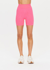 THE UPSIDE womens neon pink mid-rise Ribbed Seamless 5 Inch Spin Short made with Ribbed Seamless fabric features reverse rib panelling and moisture control properties. Perfect for yoga, pilates and barre.