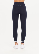 THE UPSIDE womens navy Form Seamless 25in Midi Pant made with Form Seamless fabric features contrast white stripe on ankles, soft ribbed waistband and 25-inch length leg.