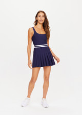 THE UPSIDE womens navy scoop neck Peach Lucette panelled mini-Dress made with Recycled Peach fabric features a pleated skirt with elastic waistband, built in shorts with pockets, and internal shelf bra.