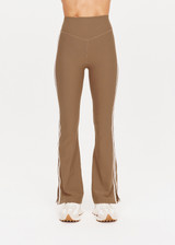 THE UPSIDE womens tan high-rise full length Peached Florence Flare pant made with Peached fabric features white stripe down side seam and split.