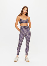 THE UPSIDE womens dark blue abstract pattern mid-rise Mystic Midi Pant made with Recycled Super Soft fabric features feathered arrow print, contrast pink embroidery and drawcord at waist.