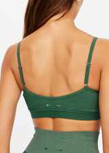 THE UPSIDE womens two-toned green pine/matcha Ribbed Seamless Ballet Bra made with Ribbed Seamless fabric features low coverage soft support, adjustable elastic straps and moisture control properties.