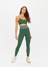 THE UPSIDE womens two-toned green pine/matcha Rib Seamless 25 Inch Midi Pant made with Ribbed Seamless fabric features soft support, reverse ribbed side panels and moisture control properties.