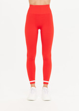 THE UPSIDE women’s red Form Seamless 25 Inch Midi Pant made with solid knit fabrication features a ⅞ leg length, white contrasting stripes on ankles and moisture wicking properties; perfect for yoga, pilates or barre.