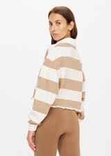 THE UPSIDE women’s brown and white Duke Crop Polo, made with Organic Cotton, is a boxy-fit cropped rugby jersey featuring wide tonal stripes, contrasting white collar, placket with button-through, mini raw frill hem and a ribbed sleeve cuff.