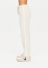 THE UPSIDE womens white straight leg Rodeo Franca Pant made with a soft organic cotton blend features elastic waistband, pockets and white stripes down sides, designed for golf.