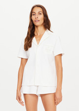 THE UPSIDE womens white, retro inspired, collared Pasadena Cubano Shirt made with organic cotton features piping trim detail, embroidered logo and snap buttons.