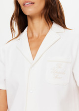 THE UPSIDE womens white, retro inspired, collared Pasadena Cubano Shirt made with organic cotton features piping trim detail, embroidered logo and snap buttons.