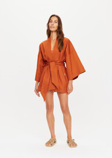 THE UPSIDE x THE BANYA orange rust robe is made from heavy organic cotton and features wide kimono-like sleeves, self-tie removable belt and welt pockets.