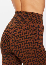 THE UPSIDE women's tobacco brown Obsidian 25 Inch High Midi Pant made with Recycled Jacquard rib fabrication in ‘T’ monogram print design features a high waisted v-front, 25 inch leg length, arrow logo at centre back and moisture wicking properties.