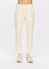 THE UPSIDE women's creme Mansi Paxton Pant made in recycled polyester fabrication features a lightweight construction, slim-fit, front patch pockets, an elasticated waistband, and water resistant/wicking properties.