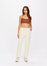 THE UPSIDE women's creme Mansi Paxton Pant made in recycled polyester fabrication features a lightweight construction, slim-fit, front patch pockets, an elasticated waistband, and water resistant/wicking properties.
