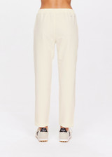 THE UPSIDE women's creme Mansi Paxton Pant made in recycled polyester fabrication features a lightweight construction, slim-fit, front patch pockets, an elasticated waistband, and water resistant/wicking properties.