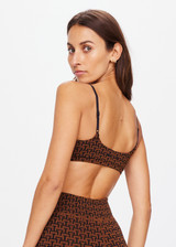 THE UPSIDE women's tobacco brown Obsidian Ballet Bra made with Recycled Jacquard rib fabrication in ‘T’ monogram print design features low coverage and soft support, adjustable straps, arrow logo at back and moisture wicking properties.