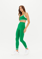 THE UPSIDE women's green mid-rise Form Seamless 25 Inch Midi Pant made in Recycled Form Seamless features a ⅞ leg length, soft ribbed waistband, contrast white stripe at ankles and arrow logo on back.