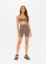 THE UPSIDE women's metallic Libertine 5 Inch Spin Short, made in specialty fabrication with a navy base and gold zig-zag design, features a mid rise fit, 5 inch leg length, and embroidered arrow on back.