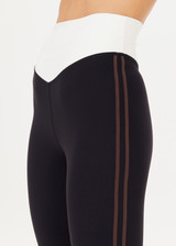 THE UPSIDE women's black high-rise Alcaraz 25 Inch High Midi Pant made with Recycled Peached fabric features a contrasting cream v-shaped waistband, cream cuffs and chocolate binds at side seams; ideal for yoga, pilates or barre.