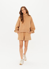 THE UPSIDE women's tan/dune Tecopa Mason Hoodie made with organic cotton loopback fabric features an oversized relaxed fit, a hood with drawcords, embroidered horseshoe logo on front, and ribbed cuffs and hemband.