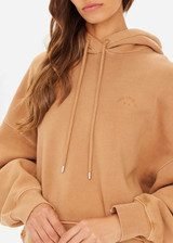 THE UPSIDE women's tan/dune Tecopa Mason Hoodie made with organic cotton loopback fabric features an oversized relaxed fit, a hood with drawcords, embroidered horseshoe logo on front, and ribbed cuffs and hemband.