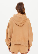 THE UPSIDE women's tan/dune Tecopa Mason Hoodie made with organic cotton loopback fabric features an oversized relaxed fit, a hood with drawcords, embroidered horseshoe logo on front, and ribbed cuffs and hemband.