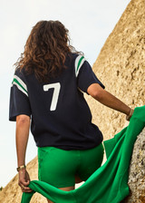 THE UPSIDE women's navy Drifter Seven Tee made in cotton viscose blend knit is a retro-style slim fit tee, featuring a contrasting green and white stripe rib at shoulder, an embroidered “7” on back and ribbed neckline.