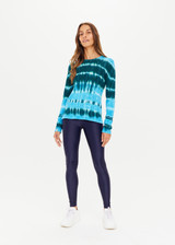 THE UPSIDE women's Tie Dye Amana Long Sleeve Knit made in 100% organic cotton features a lightweight construction, hues of blue and emerald and arrow logo pip at cuff; perfect for mid-seasonal layering.