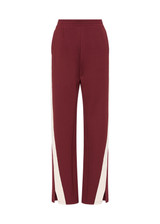 THE UPSIDE women's maroon Petra Flare is a flared pant with splits at front, contrast knitted cream tape down side seams cream tape down the side seams, pockets and elastic at waist.