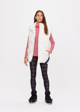 THE UPSIDE women's creme Pinnacle Oslo Puffer Gilet is made with recycled fabric for an oversized fit. This polar fleece features a snap button and zip opening. An extra warm puffer.