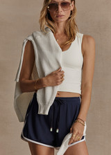THE UPSIDE women's navy Estadio Callie Short is made with recycled fabric, for a true to size fit. This mini lifestyle short features an elastic waist with side seam pockets.